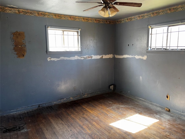 unfurnished room with dark hardwood / wood-style floors and ceiling fan