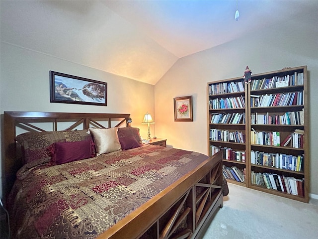 bedroom featuring lofted ceiling and carpet