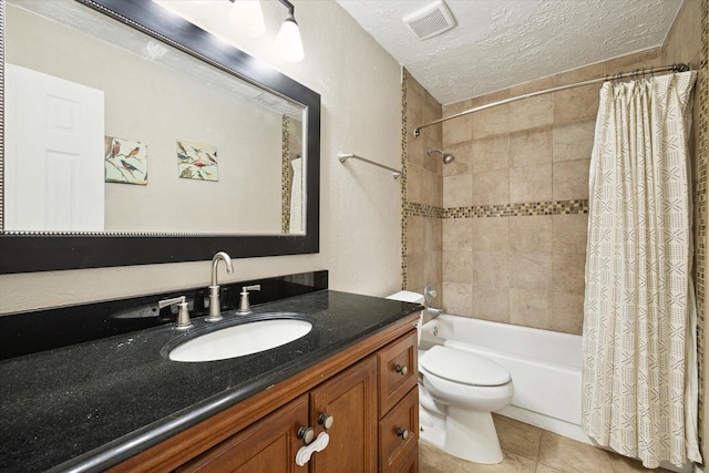 full bathroom with shower / tub combo with curtain, tile patterned flooring, vanity, a textured ceiling, and toilet