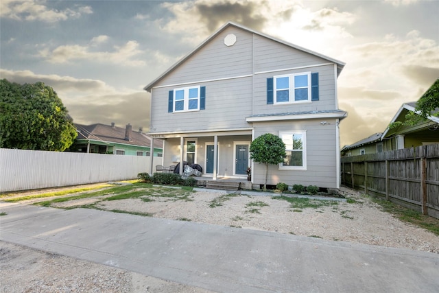 view of front of home featuring a porch and fence private yard