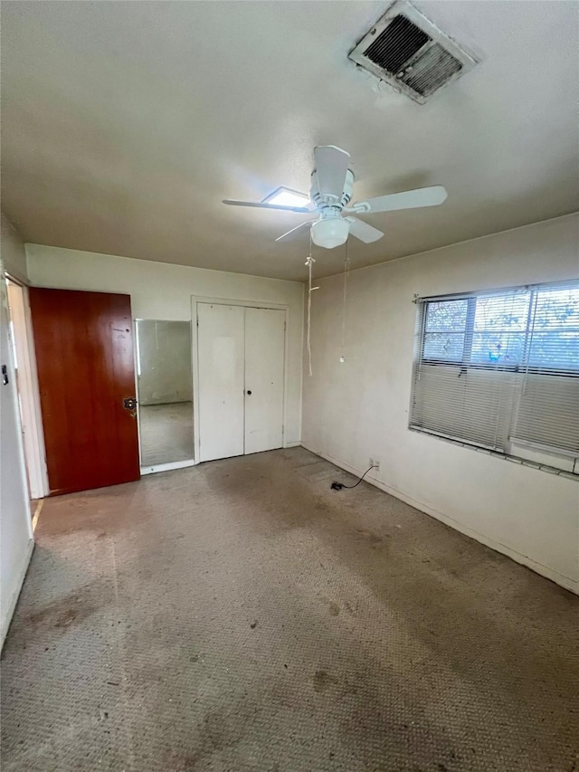 unfurnished bedroom featuring light carpet and ceiling fan