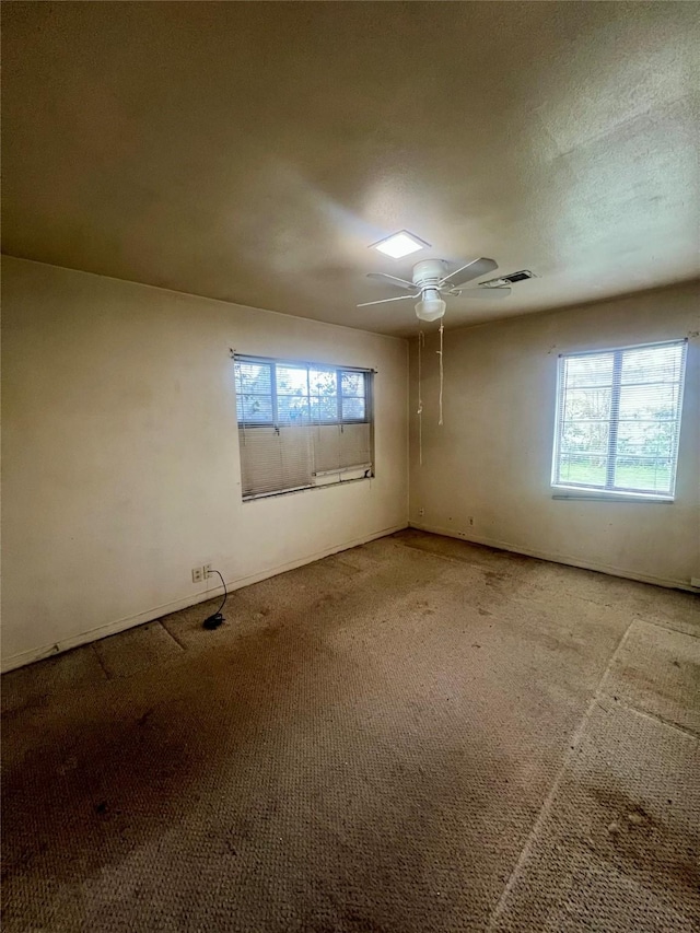 empty room featuring ceiling fan and carpet flooring