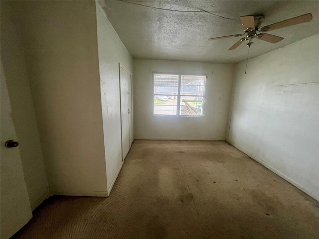 spare room featuring ceiling fan and a textured ceiling