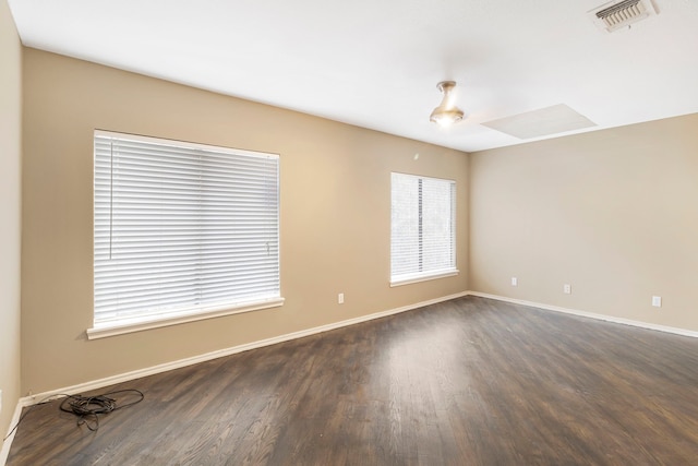 spare room featuring dark wood-type flooring