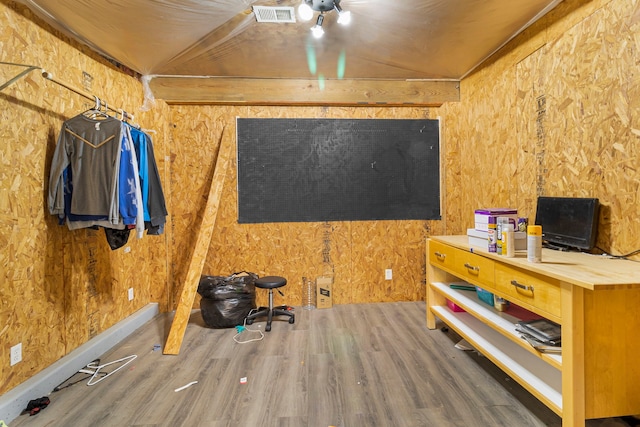 miscellaneous room with lofted ceiling and dark hardwood / wood-style floors