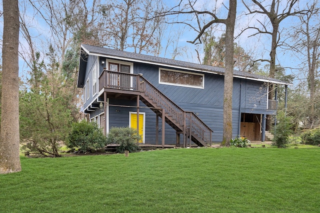 back of house featuring a deck and a lawn