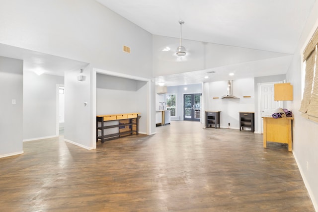 living room with high vaulted ceiling and dark hardwood / wood-style flooring