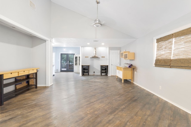 living room featuring dark hardwood / wood-style floors, high vaulted ceiling, and french doors