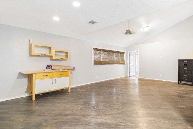 unfurnished living room featuring lofted ceiling and dark hardwood / wood-style flooring