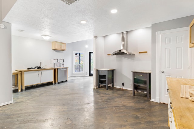 kitchen featuring a textured ceiling, dark hardwood / wood-style flooring, stainless steel dishwasher, wall chimney exhaust hood, and light brown cabinets