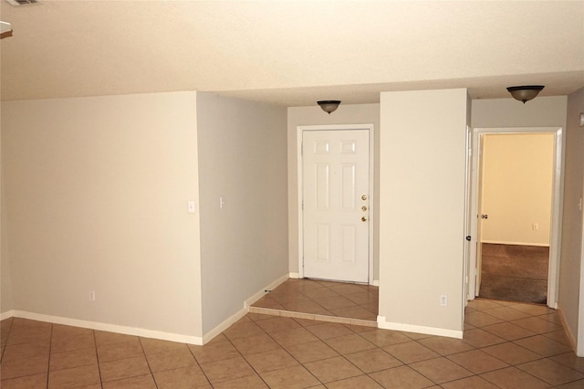 spare room with tile patterned floors