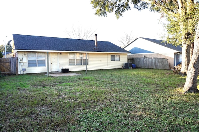 rear view of property with a patio, a lawn, and central air condition unit