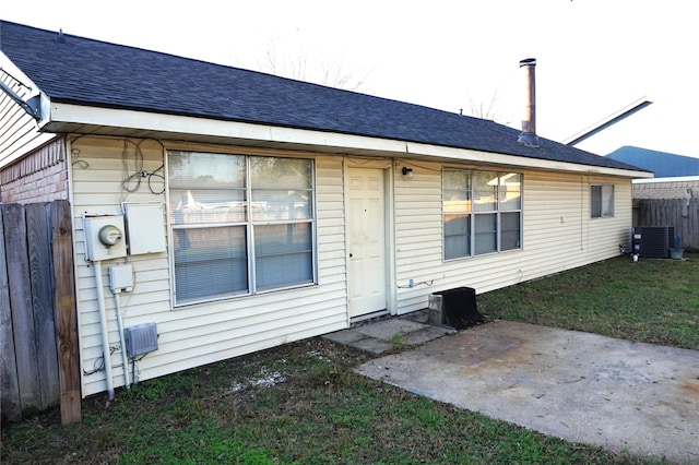 back of property with central air condition unit and a patio area