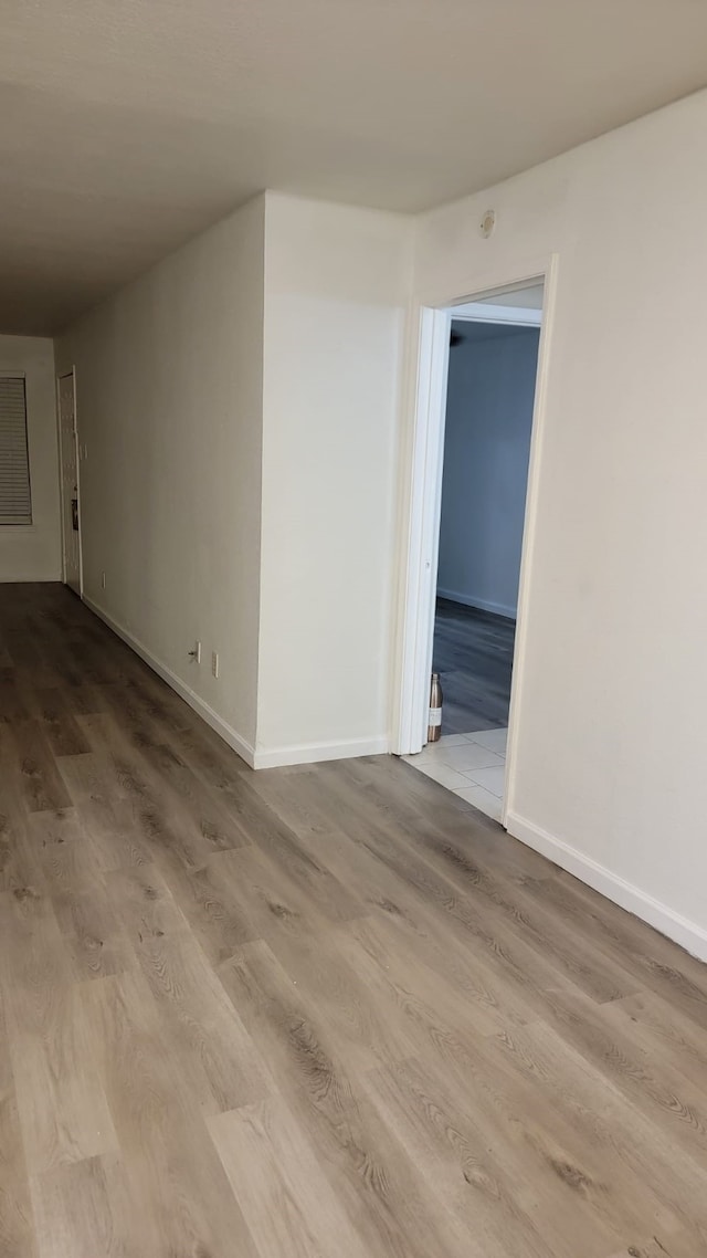 empty room with light hardwood / wood-style flooring