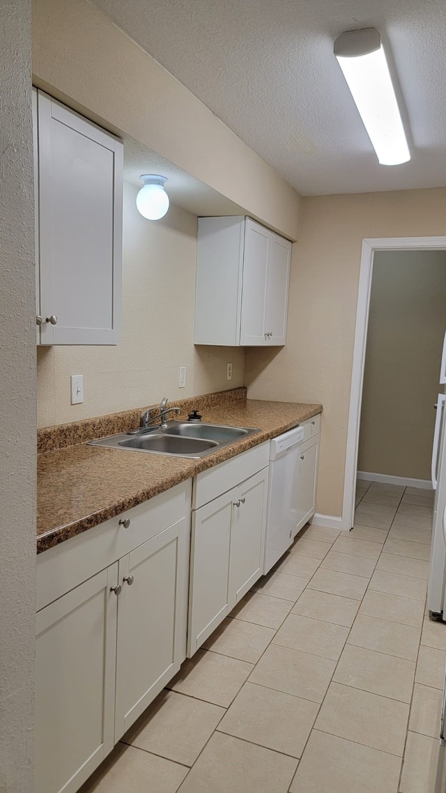 kitchen with dishwasher, sink, white cabinets, and a textured ceiling