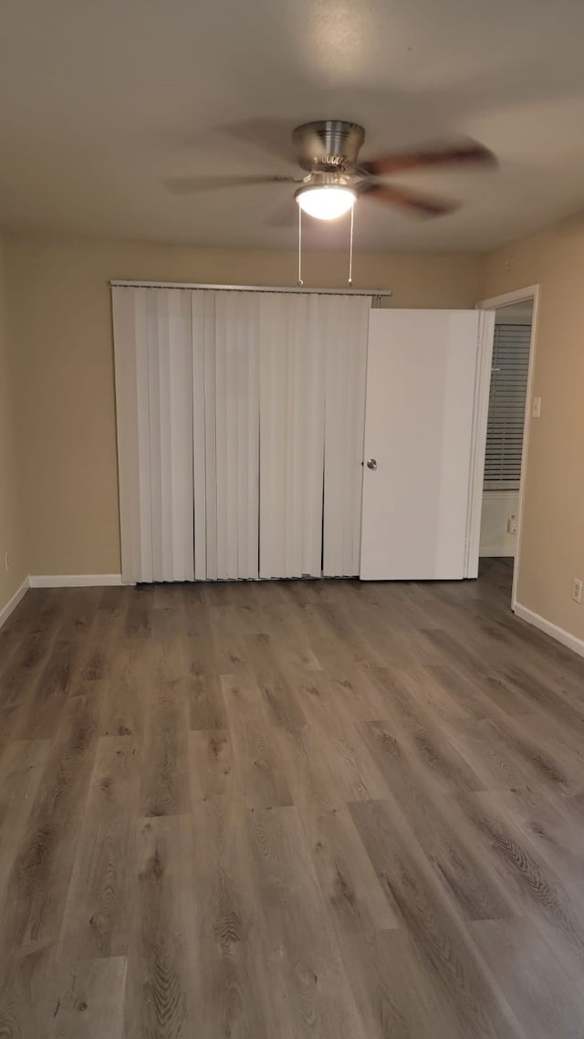 spare room with wood-type flooring and ceiling fan