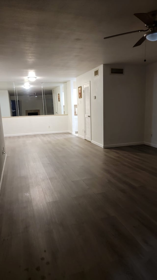 empty room featuring wood-type flooring and ceiling fan