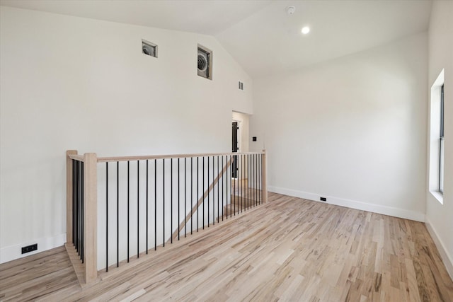 interior space featuring light hardwood / wood-style floors and vaulted ceiling