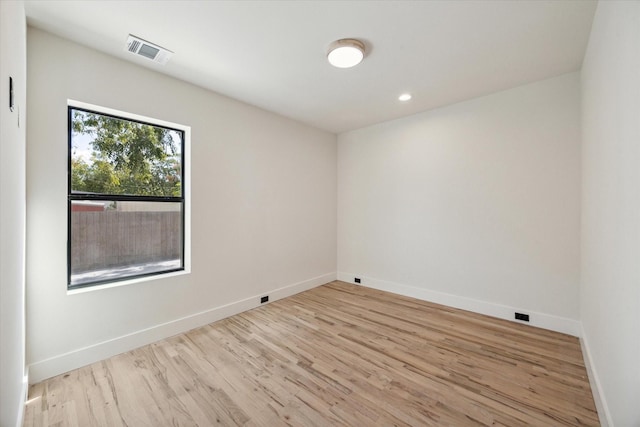 spare room featuring light hardwood / wood-style floors