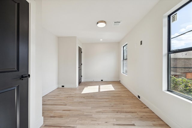 spare room featuring light hardwood / wood-style flooring