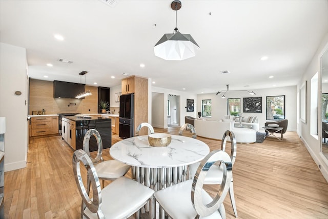 dining room with light hardwood / wood-style flooring