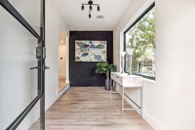 corridor with light hardwood / wood-style floors