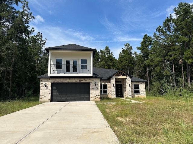 1037 Rd 6609, Dayton, TX 77535 - view of front facade with an attached garage, a balcony, driveway, french doors, and brick siding