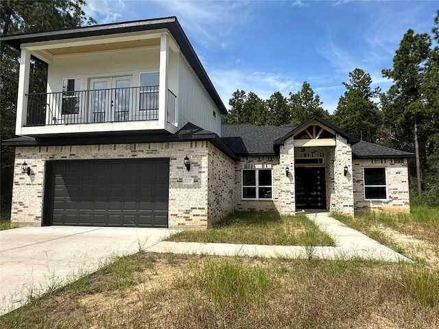 1037 Rd 6609, Dayton, TX 77535 - view of front facade featuring brick siding, a balcony, an attached garage, and driveway