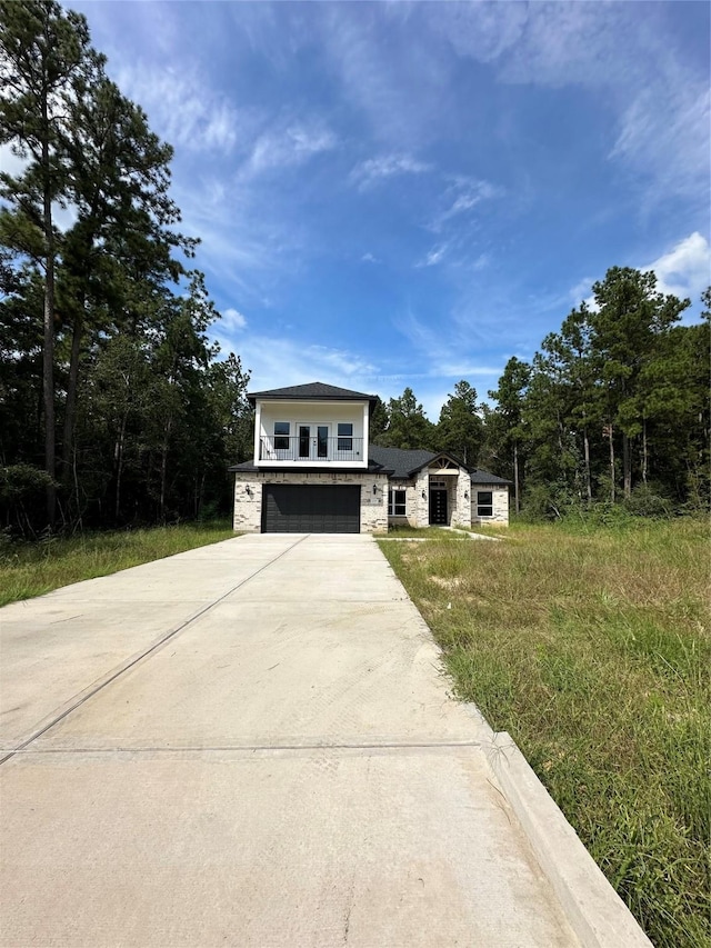 1037 Rd 6609, Dayton, TX 77535 - view of front of house featuring an attached garage, stone siding, and driveway