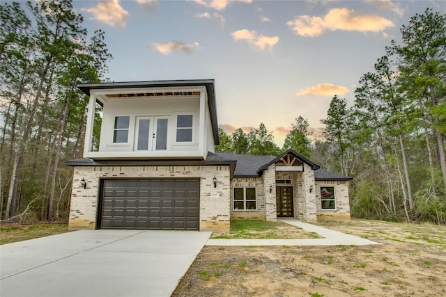 1037 Rd 6609, Dayton, TX 77535 - contemporary home featuring brick siding, a garage, driveway, and french doors