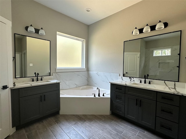 bathroom with vanity and a tub