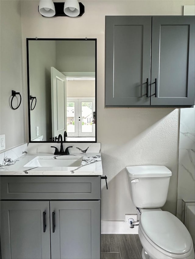 1037 Rd 6609, Dayton, TX 77535 - bathroom featuring vanity, toilet, wood finished floors, and baseboards