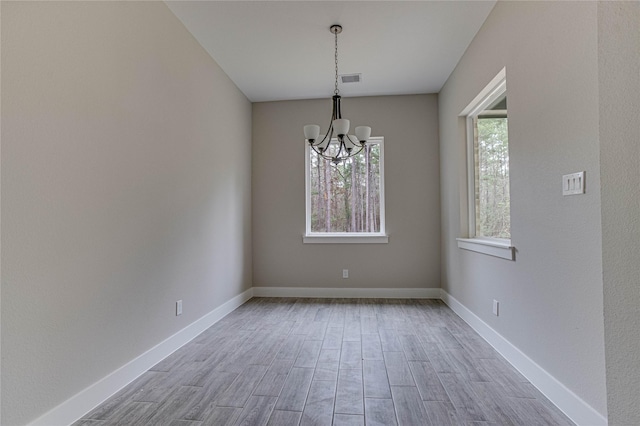 1037 Rd 6609, Dayton, TX 77535 - spare room with a chandelier, wood finished floors, and baseboards