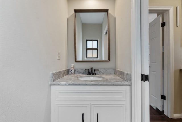 bathroom with wood finished floors and vanity