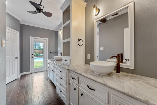 bathroom with ceiling fan, ornamental molding, vanity, and hardwood / wood-style floors