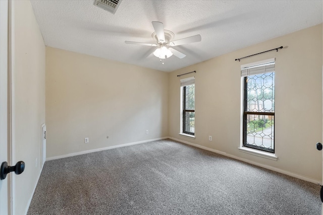 carpeted spare room with ceiling fan and a textured ceiling