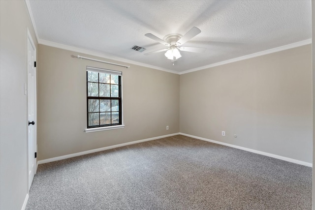 carpeted empty room with baseboards, visible vents, a ceiling fan, and ornamental molding