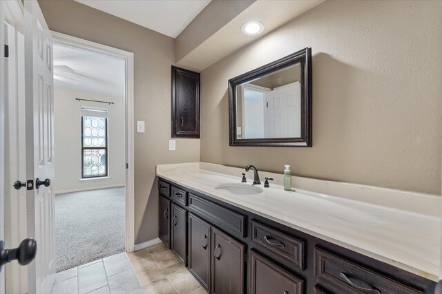 bathroom featuring tile patterned flooring, baseboards, and vanity