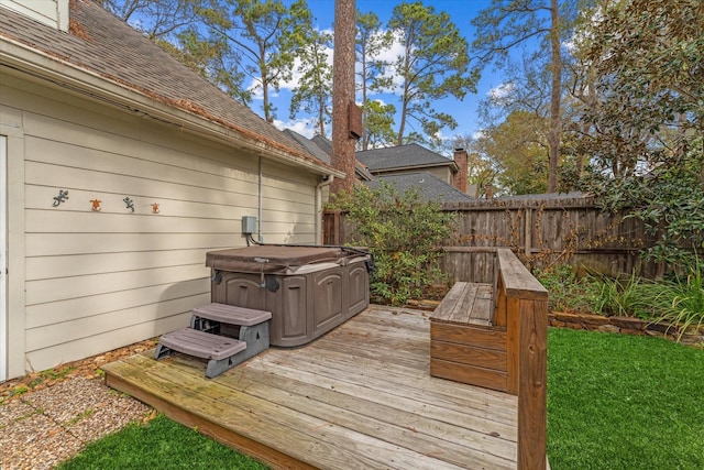 wooden deck with a hot tub