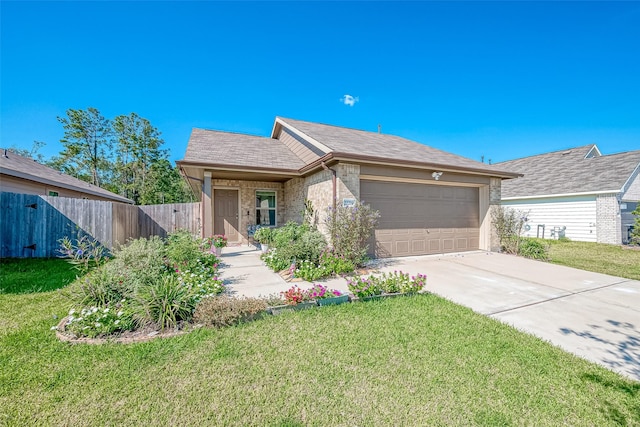 ranch-style house featuring a garage and a front lawn