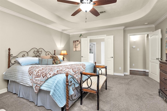 bedroom with ornamental molding, a raised ceiling, ceiling fan, and carpet