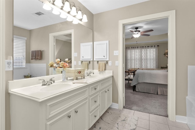 bathroom with tile patterned flooring, vanity, and ceiling fan