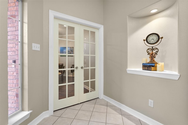 doorway to outside featuring light tile patterned floors and french doors