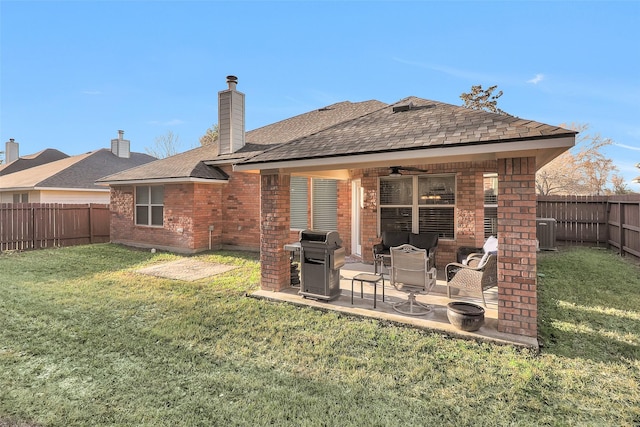 back of property featuring a yard, central AC, ceiling fan, and a patio area