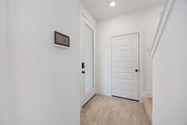 doorway to outside with light wood-type flooring