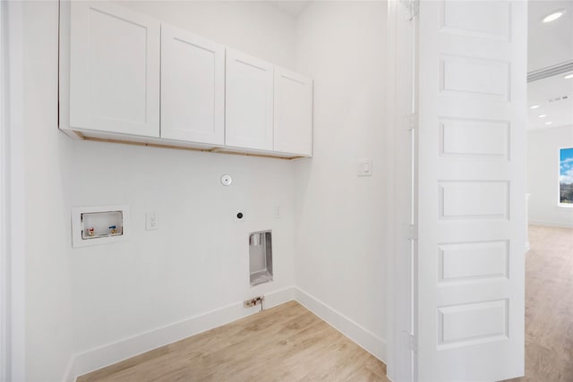 laundry area with hookup for a washing machine, gas dryer hookup, electric dryer hookup, and cabinets