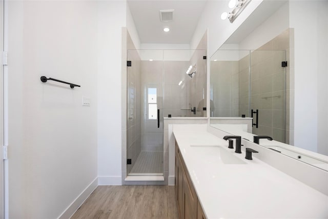 bathroom featuring vanity, hardwood / wood-style floors, and an enclosed shower