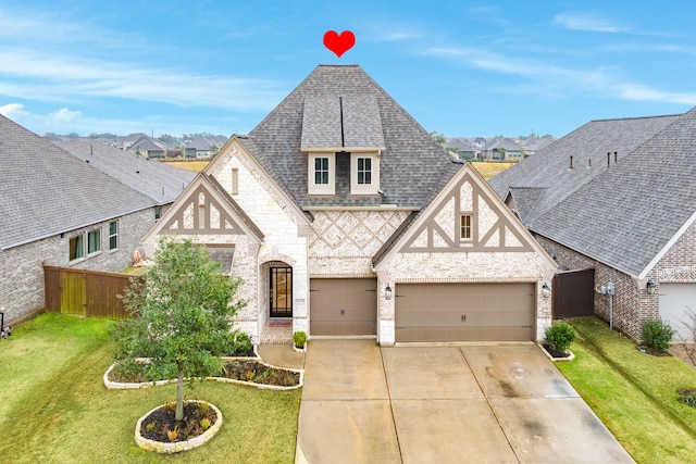 view of front of home with a garage and a front lawn