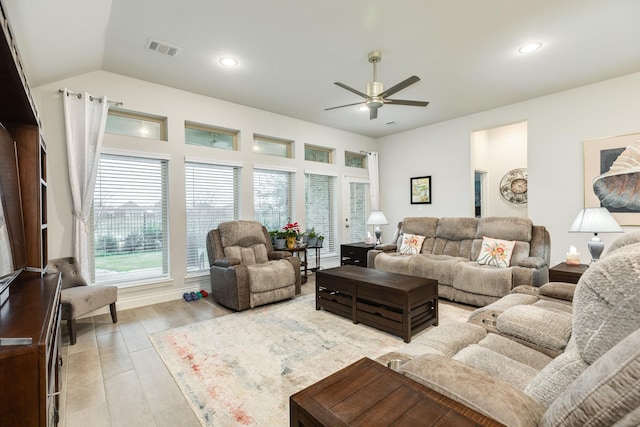 living room with vaulted ceiling, ceiling fan, and light wood-type flooring