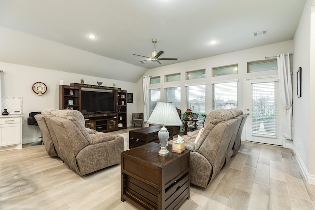 living room featuring ceiling fan, lofted ceiling, and light wood-type flooring